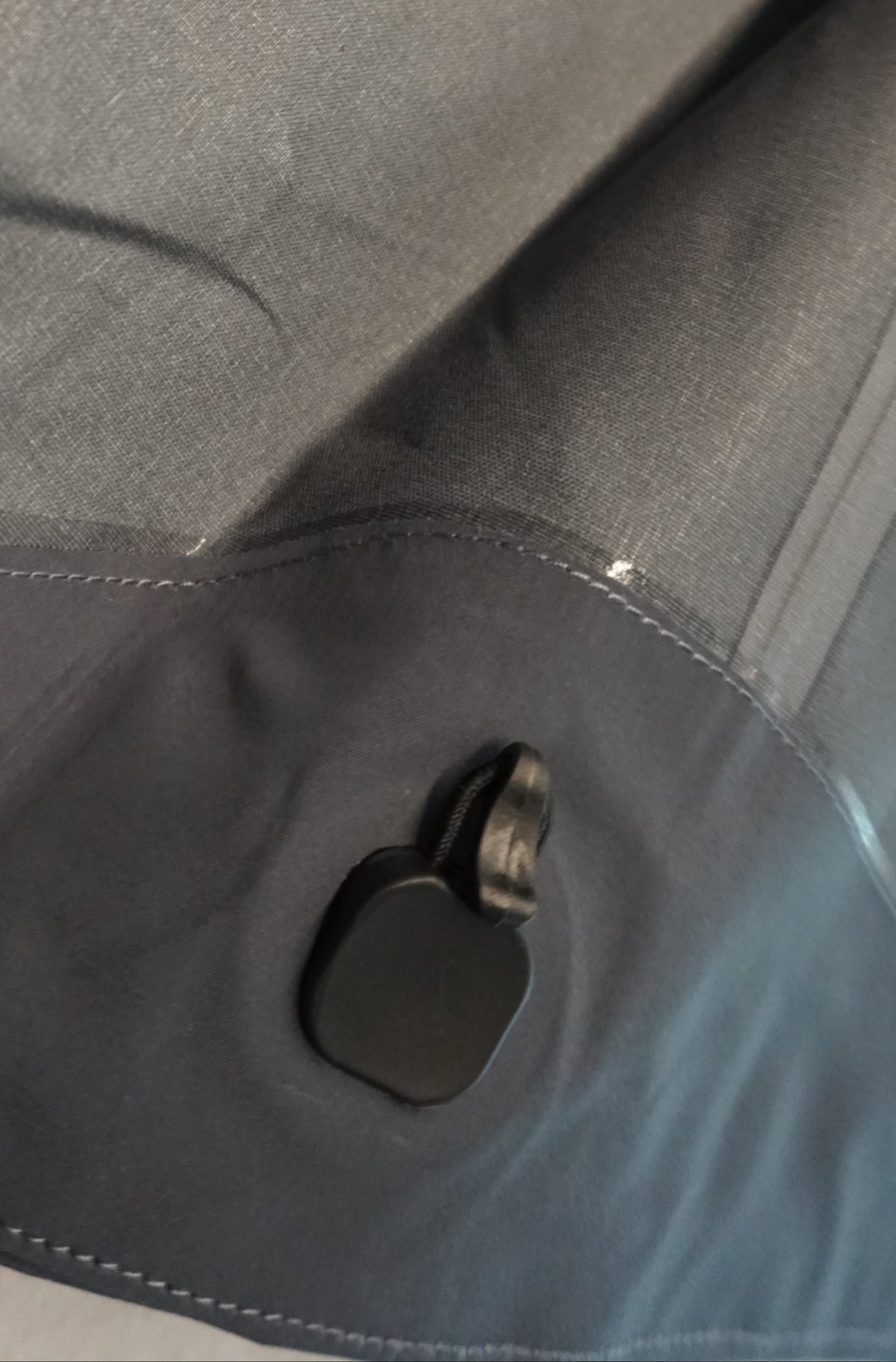 Inside of a grey technical shell showing the elastic hem sinch.