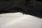 A close up of the pit zippers on a black snow shell.