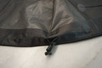 Close-up of the hem sinch of a black waterproof shell.
